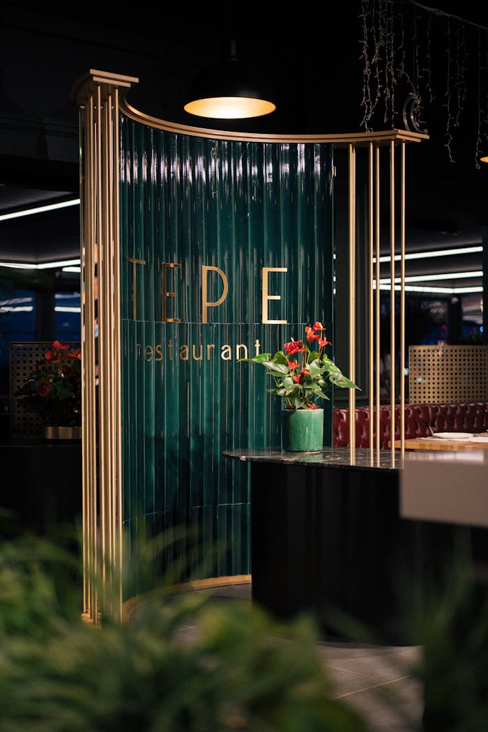 Stylish and inviting restaurant entrance with modern decor and vibrant flowers.
